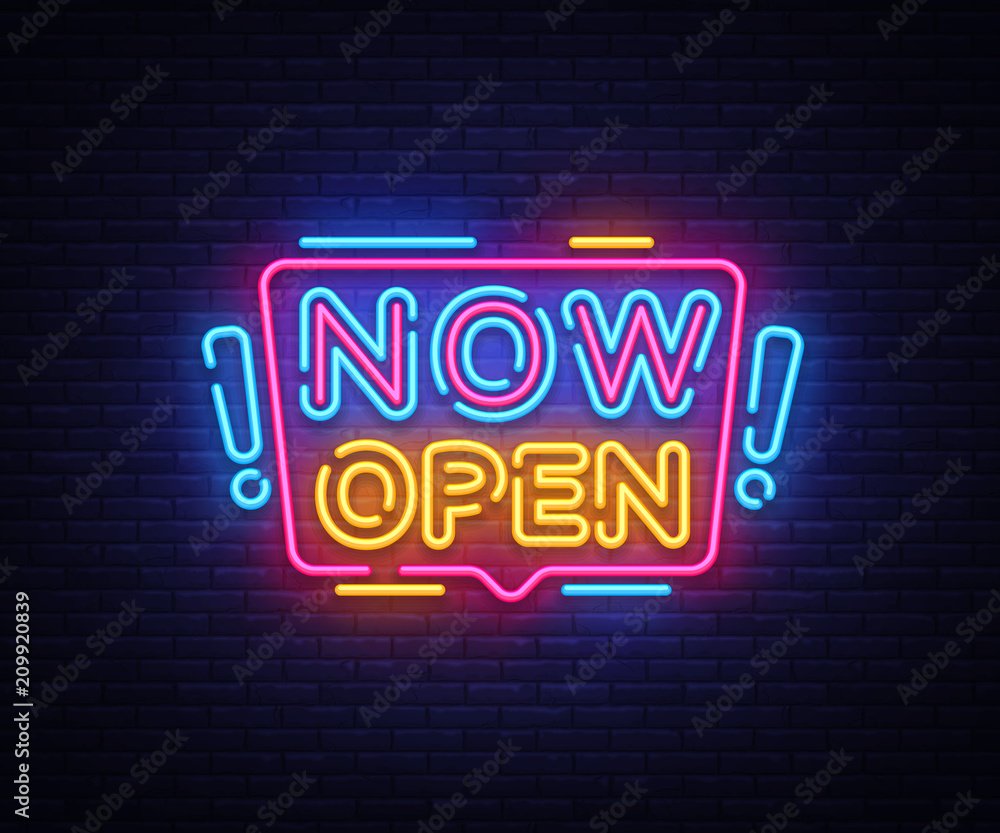 NOW OPEN” neon text in bright colors—modern use of neon signs for promotional visibility