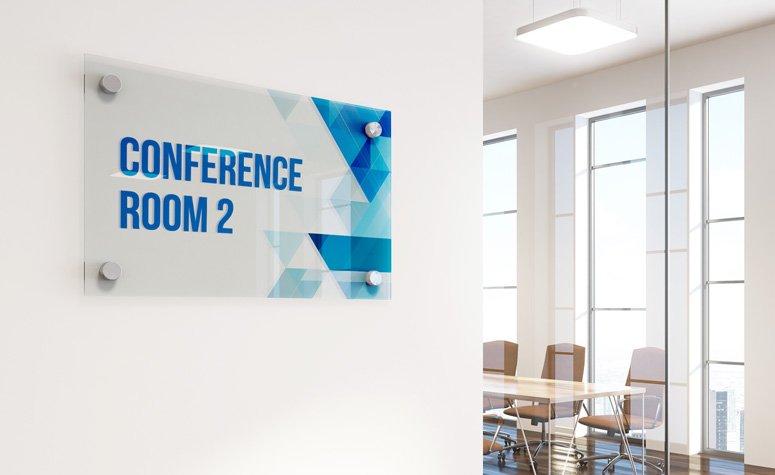 Laser-cut acrylic 3D logo sign installed on a reception wall for branding in a corporate setting.