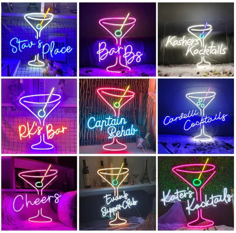 Collection of colorful custom neon signs including cocktail icons, crowns, and stylized text glowing on a dark wall.”