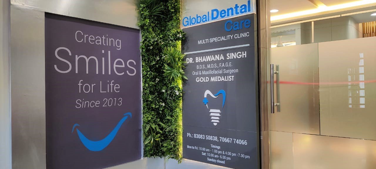 Wall-mounted clear acrylic sign with logo, displayed in a sleek office environment.