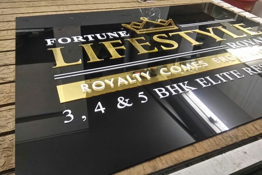 A bold acrylic sign board featuring 3D LED‑lit letters showcasing a brand name in high-contrast style.