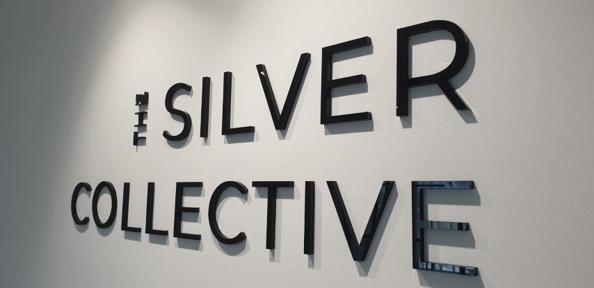 Frosted wall-mounted acrylic signs Sydney with company name and logo.